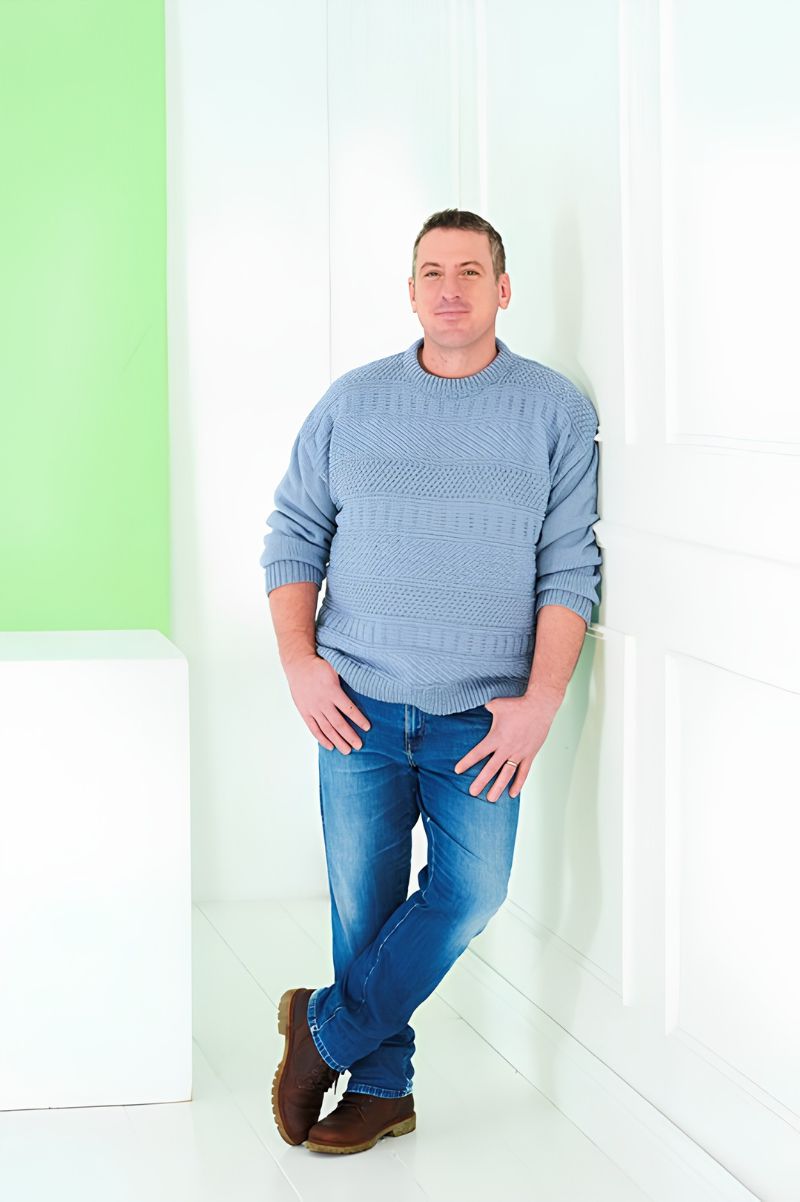 Man wearing a Stylecraft pattern knitted sweater with round neck.