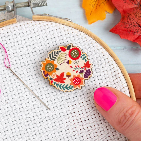 Magnetic Needle Minder in an Autumn Leaves Design from Hawthorn Handmade, with a cross stitch hoop behind