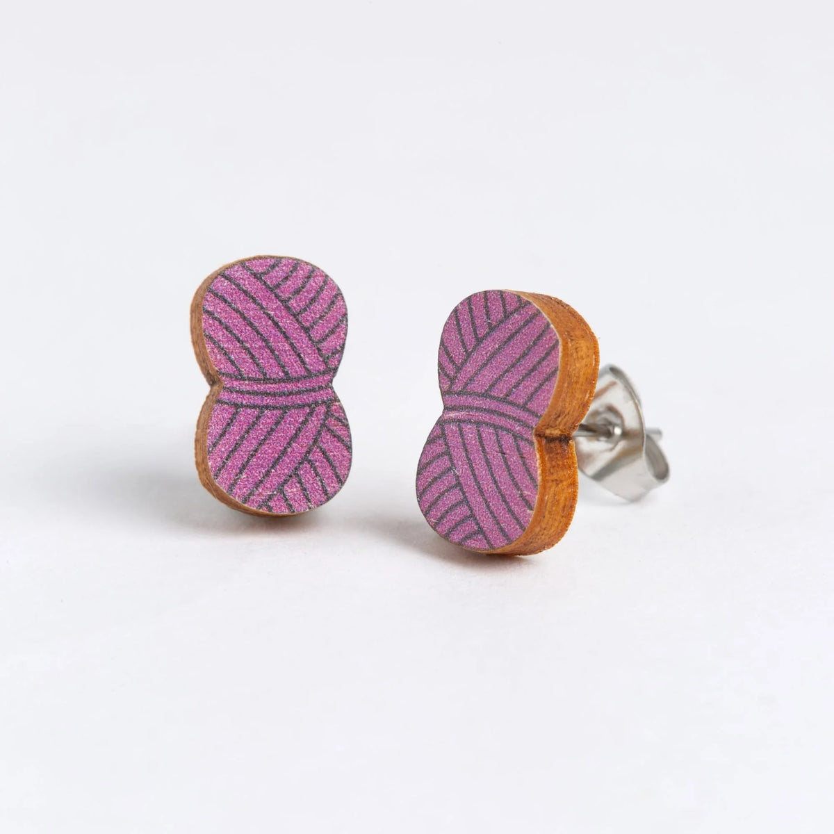 Ball of wool earrings in Mauve on a white background.