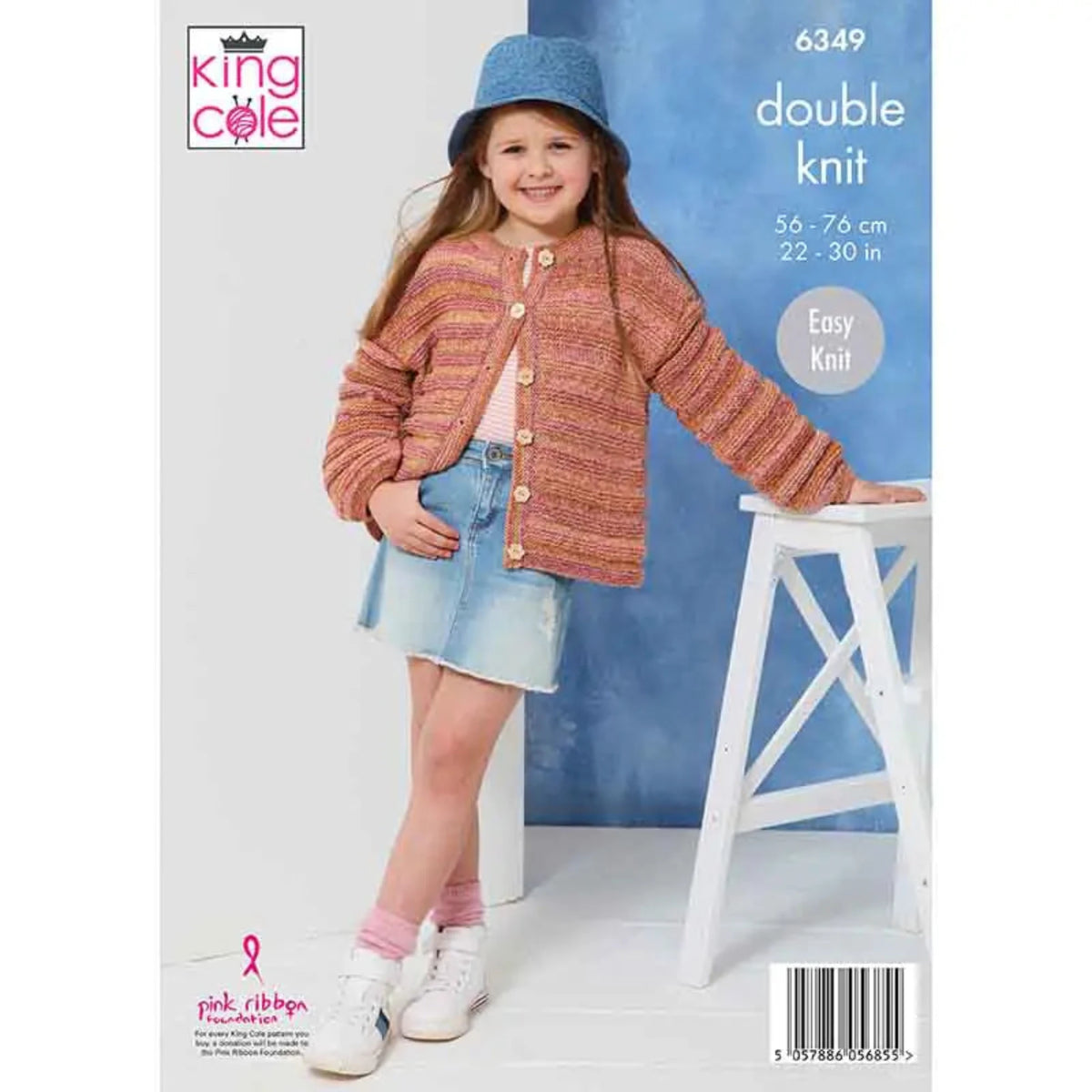 Knitting pattern 6349 for a child's cardigan with a the model stood in front of a blue backdrop. She is also wearing a denim skirt and bucker hat, pink socks and white trainers. The text on the pattern is King Cole, 6349, Double Knit, Easy Knit. It also says the sizes are 56-76 cm and 22-30 in.