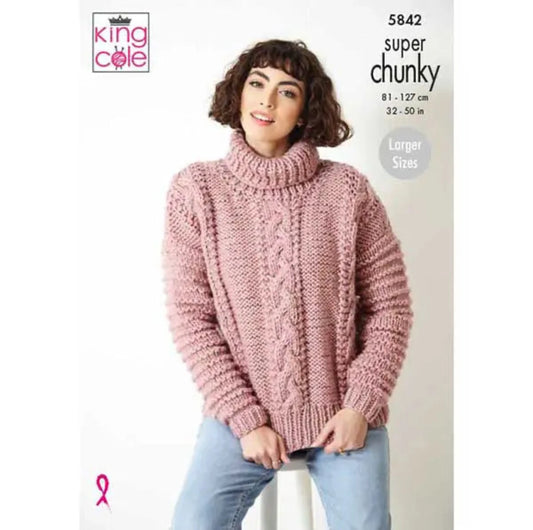 King Cole knitting pattern cover showing a woman wearing a pink super chunky knit sweater. She also wearing blue jeans.