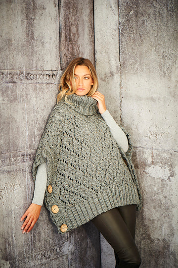 A light grey diamond pattern poncho with a high neck and 3 chunky buttons on either side